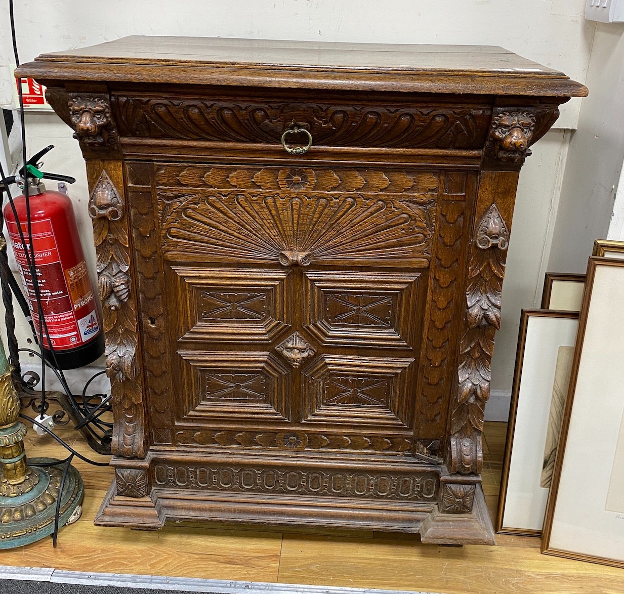 A late 19th century Flemish carved oak side cabinet, width 89cm, depth 50cm, height 104cm